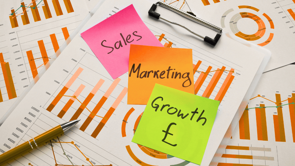 Sales, marketing, and growth concept with colourful sticky notes on financial charts and graphs – representing results-driven food & drink marketing.